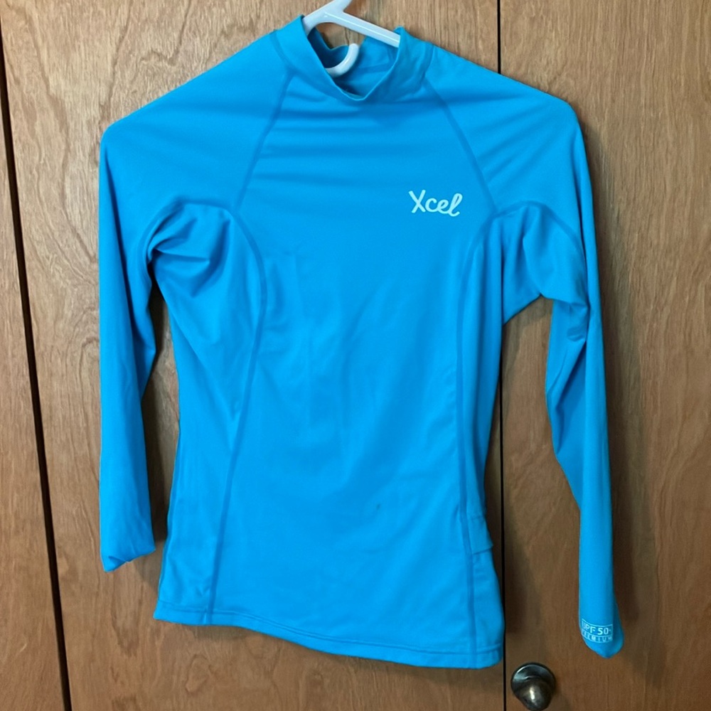 Light blue Xcel Rash guard. Size 6. Cute and comfy lightly used